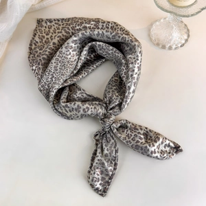 Detail of leopard print silk headscarf with metallic luster in vintage Y2K aesthetic