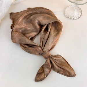 Detail of silk-like brown headscarf with marble texture and elegant single knot style