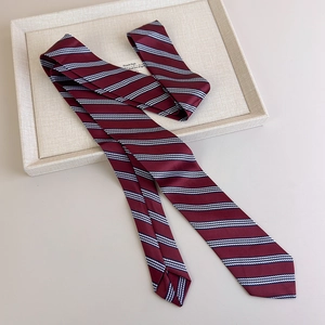 Macro detail of the wine red striped tie texture and smooth silk-like fabric finish