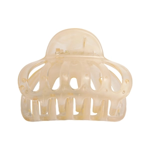 Detailed macro view of translucent amber hair claw clip with strong metal spring