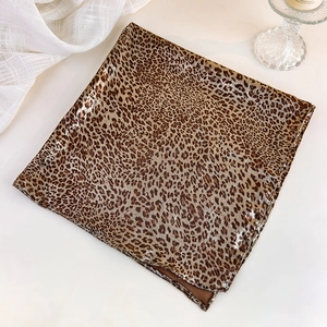 Detail view of foldable leopard print square scarf with silky texture and fine edges