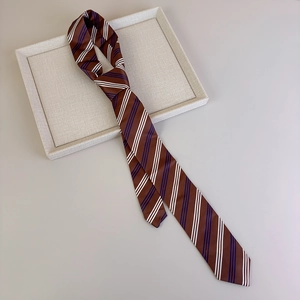Detail shot of the textured brown striped tie showing premium woven fabric and diagonal pattern