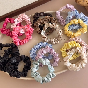 3-pack satin scrunchie set in vibrant candy colors displayed on a ceramic tray
