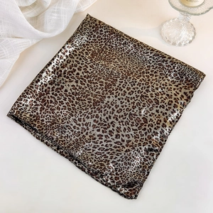 Detail shot of leopard print square scarf with metallic luster and silky texture