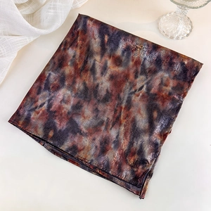Detail of vintage Y2K tie-dye square scarf in brown and black with silk satin luster