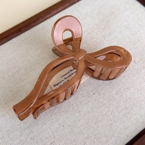 Detailed macro view of the amber transparent resin hair claw clip with a glossy finish
