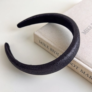 Detail view of thickened black headband with silver glitter finish and foam padding