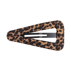 Macro detail of the leopard print fabric texture on a triangular metal BB hair clip