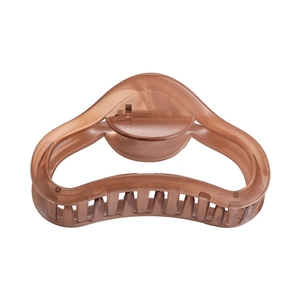 Detail of coffee brown translucent resin hair claw clip with smooth curved design