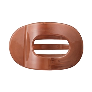 Detailed view of an amber translucent hair claw clip with a hollow oval design