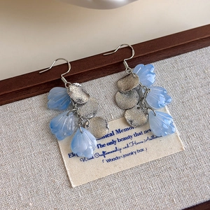 Gradient blue petal earrings with silver textured discs and elegant ear hooks