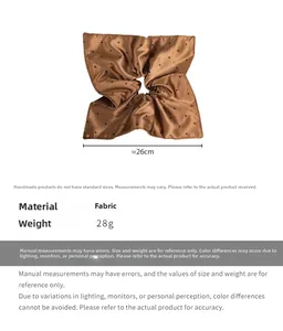 Detailed view of large brown polka dot hair scrunchie showing 26cm diameter and 28g weight