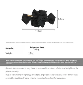 Detail showing a black layered bow hair clip with a gold Love charm and size dimensions