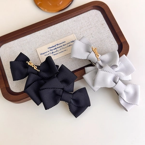 Elegant layered bow hair clips in black and silver with gold Love metal hardware