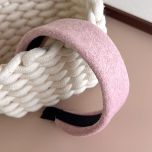 Close-up of thick pink wool-like headband with soft texture and non-slip lining