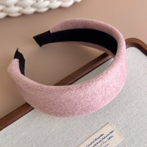 Close-up of thick plush wool wide headband in soft dusty pink with warm texture