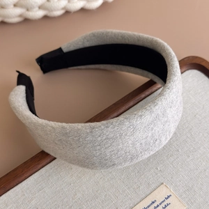 Close-up of light grey wool wide headband with soft texture and non-slip inner lining