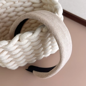 Close-up of beige wool texture on thick wide headband for a cozy winter style