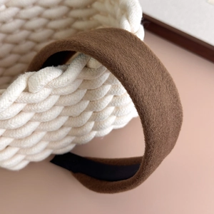 Close-up detail of dark brown wool texture headband with black anti-slip lining
