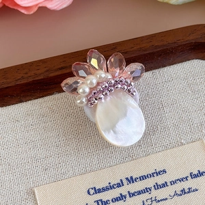 Vista macro di ciondolo floreale fatto a mano con cristalli rosa e perle per scarpe DIY