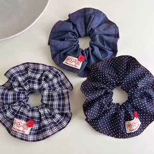 Detailed set of three fabric hair scrunchies with denim, plaid and polka dot patterns