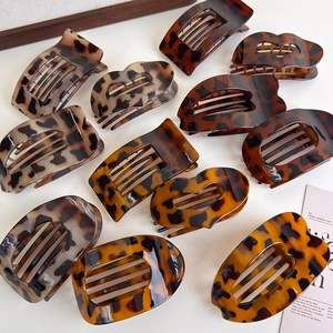 Flat lay of diverse leopard print claw clips with various shapes and amber textures