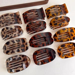 Macro view of leopard print hair clips set in various shapes on a white background