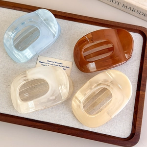 Elegant set of 4 large acetate hair clips in macaron colors displayed on a tray