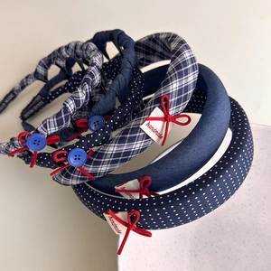Detailed view of plaid and polka dot fabric headbands with bows and buttons