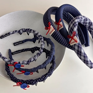British style plaid and polka dot headband set with red handmade bow in a ceramic tray