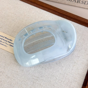 Detail of light blue marble acetate hair claw clip with strong metal spring support