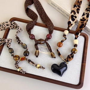 Vintage leopard print beaded scarf necklace with adjustable fabric layers and heart charm
