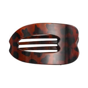 Detailed close-up of large leopard print hair claw with hollow oval design and smooth texture