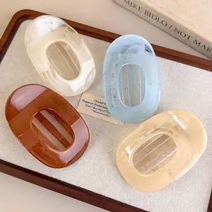 Set of four macaron color marble texture large acrylic hair claws in a wooden tray