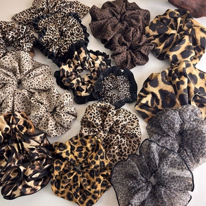 Set of assorted leopard print scrunchies in various brown and beige patterns for ponytails
