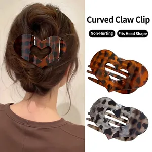 Ergonomic leopard print claw clip for women featuring a curved heart-shaped hair accessory