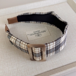 Detailed macro of vintage brown plaid wide headband with a square resin buckle feature