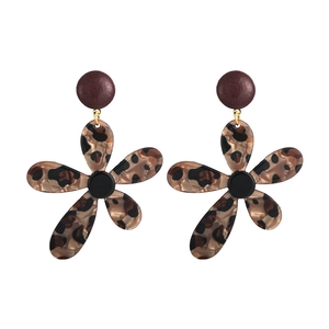 Macro view of flower stud earrings featuring leopard print petals and resin textures