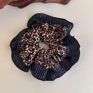 Detail view of large leopard print scrunchie with elegant black pleated fabric edges