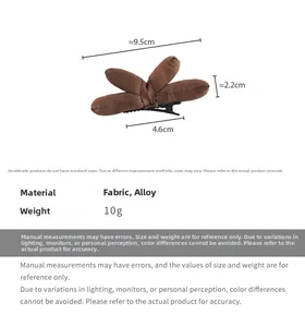 Detailed view of handmade dark brown fabric dragonfly hair clip with size dimensions