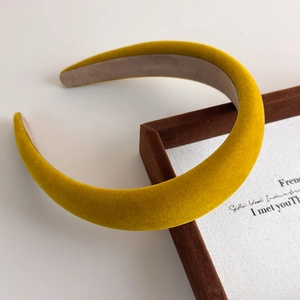 Close-up of bright yellow velvet padded headband with soft vintage texture detail