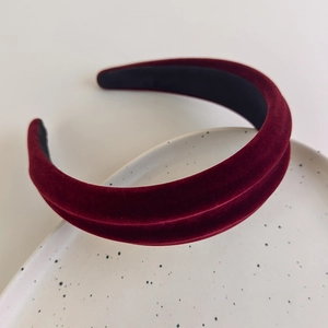 Detail of burgundy velvet padded headband showing premium plush texture and luxury design