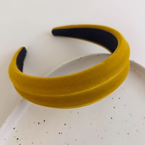 Macro shot of ginger yellow velvet padded headband showing premium plush texture and stitching