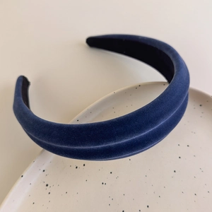 Close-up of velvet wide headband showing soft texture and premium blue fabric finish