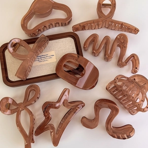 Amber jelly claw clips set with butterfly and star shapes on a clean white background