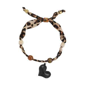 Detail of leopard print silk scarf necklace with heart pendant and geometric beads