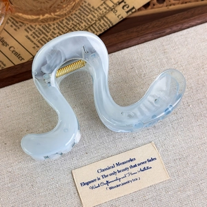 Detail of jelly blue wave hair claw clip with pearlescent finish on vintage background