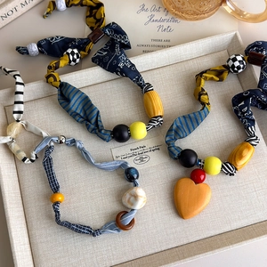 Bohemian patchwork fabric necklace with colorful beads and heart pendant in vintage setting