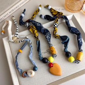 Bohemian handmade fabric patchwork necklace with colorful wooden beads and heart pendant
