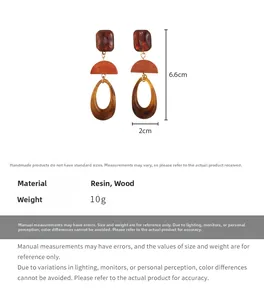 Detail view of oval drop earrings with resin and wood in amber and reddish brown hues